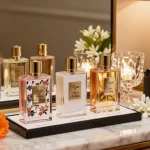 Kilian Love Don't Be Shy perfume samples displayed beautifully among fragrant flowers, evoking luxury and elegance.